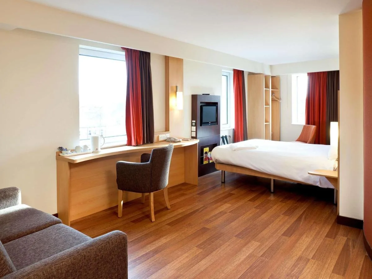 a hotel room with a bed and a desk at ibis Belfast Queens Quarter in Belfast
